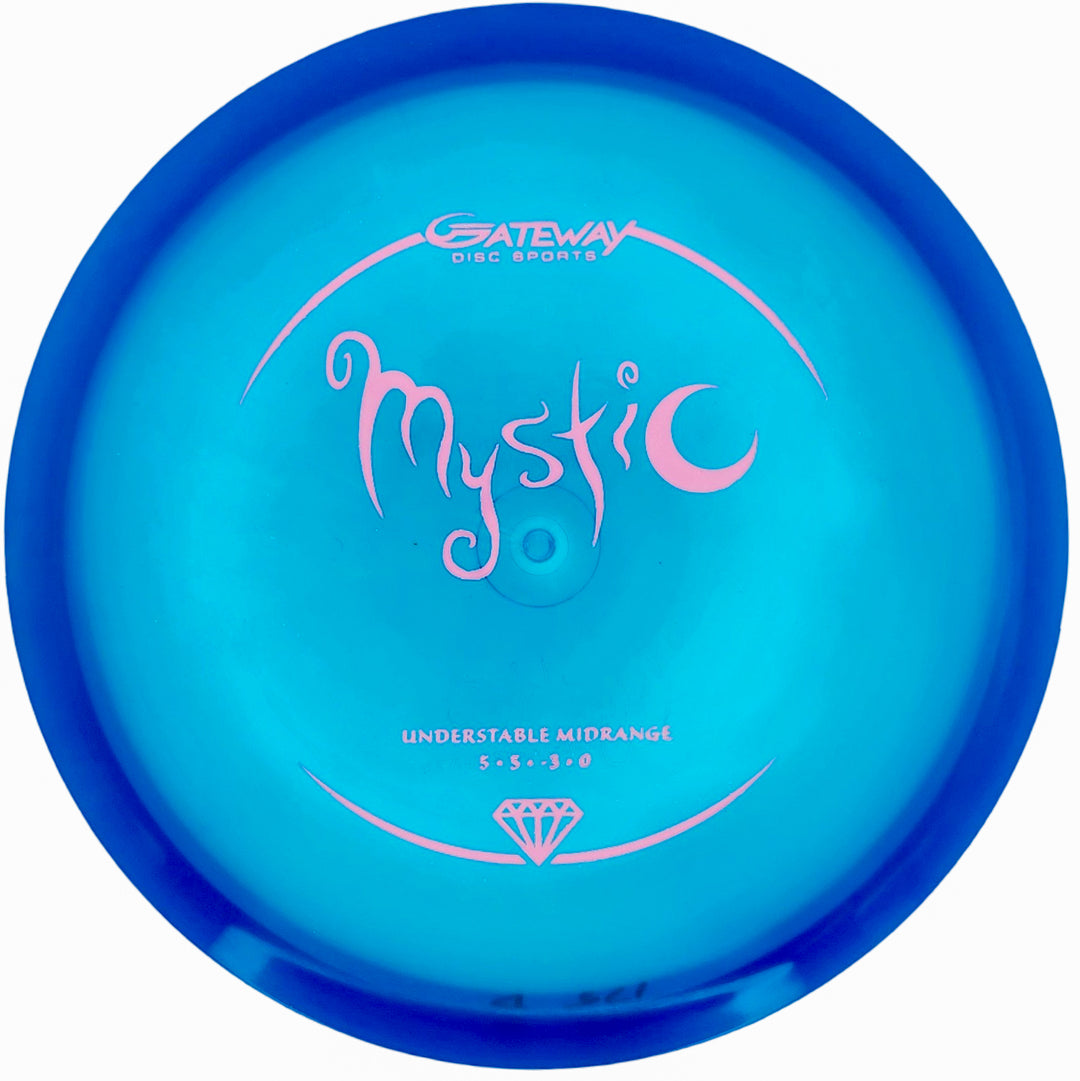 The Mystic - Diamond by Gateway Disc Sports is a blue disc golf disc featuring "Mystic" in pink text, designed for players who want controllable mid-range throws and a dependable straight flight.