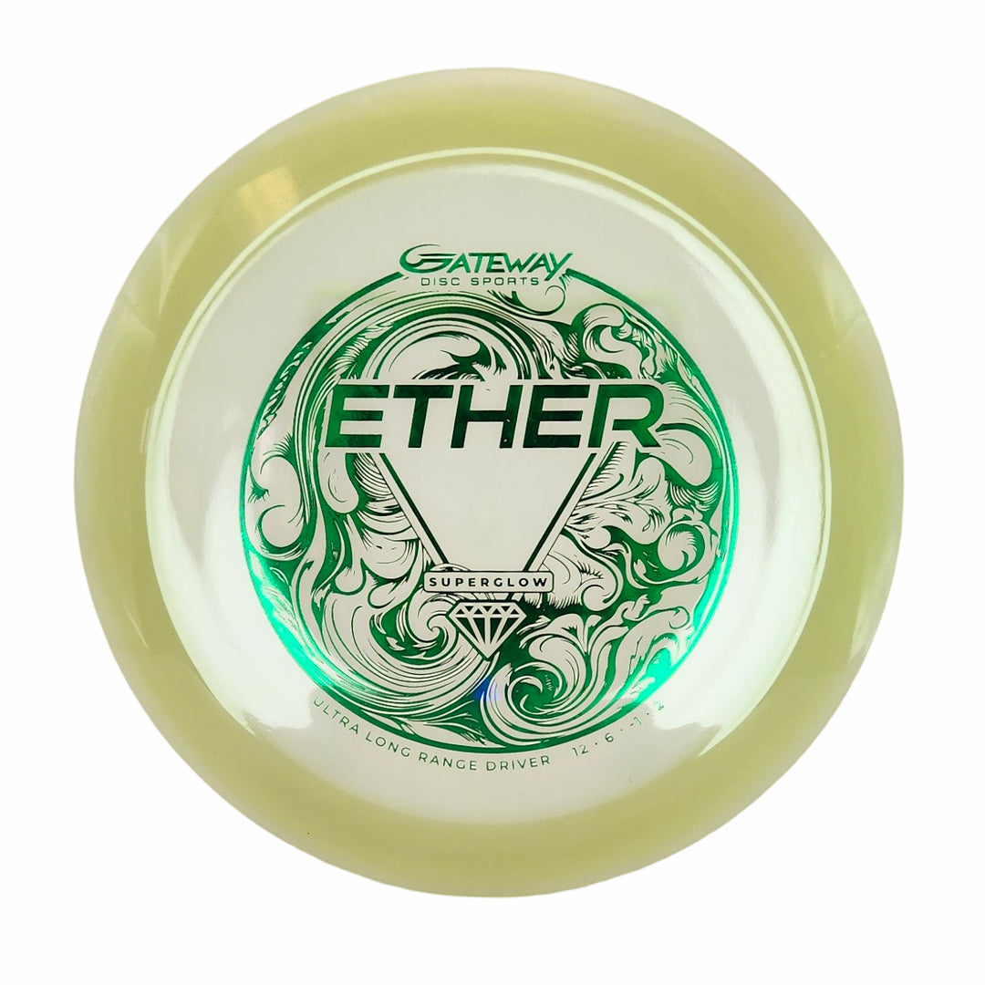 The Ether - Diamond Superglow is a yellow-green ultra long range distance driver with decorative green designs on a white center, featuring "Gateway Disc Sports" branding€”ideal for max distance throws.