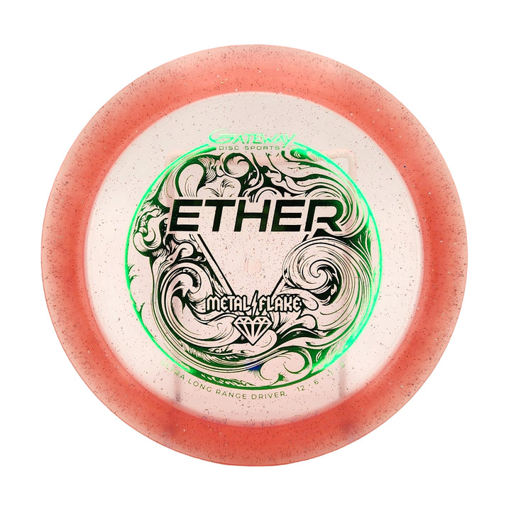 The Ether - Diamond Metal Flake is a round, PDGA-approved distance driver with a translucent pink rim, clear center, green and black "ETHER" design, plus "Metal Flake" and "Gateway Disc Sports" text—crafted for max distance.