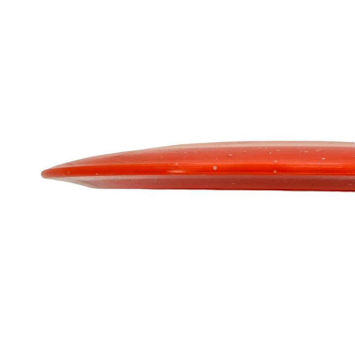 The Ether - Diamond Metal Flake surfboard, shown from the side against a white background, features a streamlined profile reminiscent of a PDGA approved distance driver for maximum distance shots.