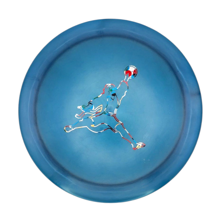 The Realm - Diamond - Air Dude features a blue plate with a stylized soccer goalie leaping to catch a ball, reflecting the dynamic energy of this max distance driver.