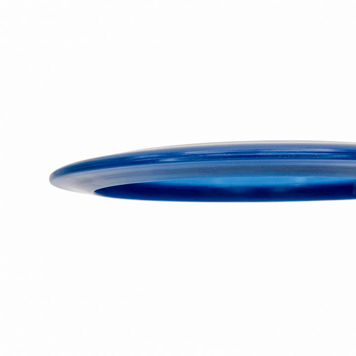 Close-up of the edge of the Realm - Diamond - Air Dude blue plastic max distance driver against a white background.