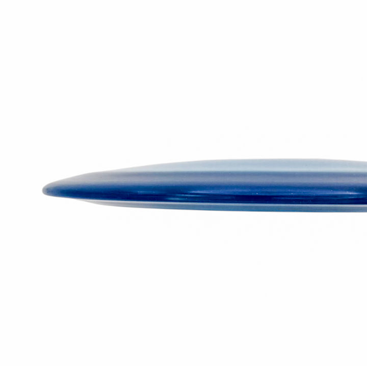A close-up side view of the rounded, blue edge of the Realm - Diamond - Air Dude max distance driver surfboard against a white background.