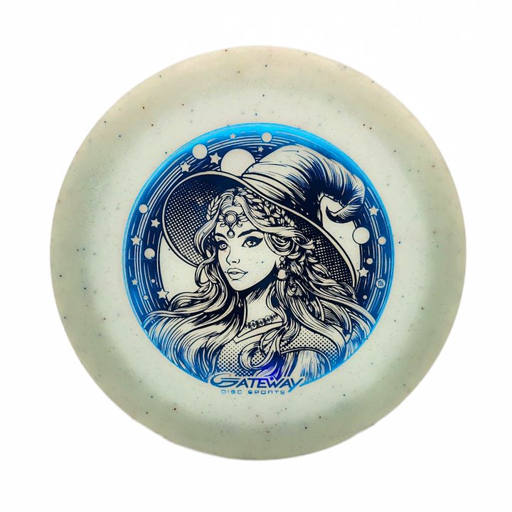 The Spell NXT Superglow - PremierJul is a white glow plastic disc golf disc with a blue design of a woman in a pointed hat and decorative pattern, plus the "Gateway Disc Sports" logo—ideal for overstable driver fans.