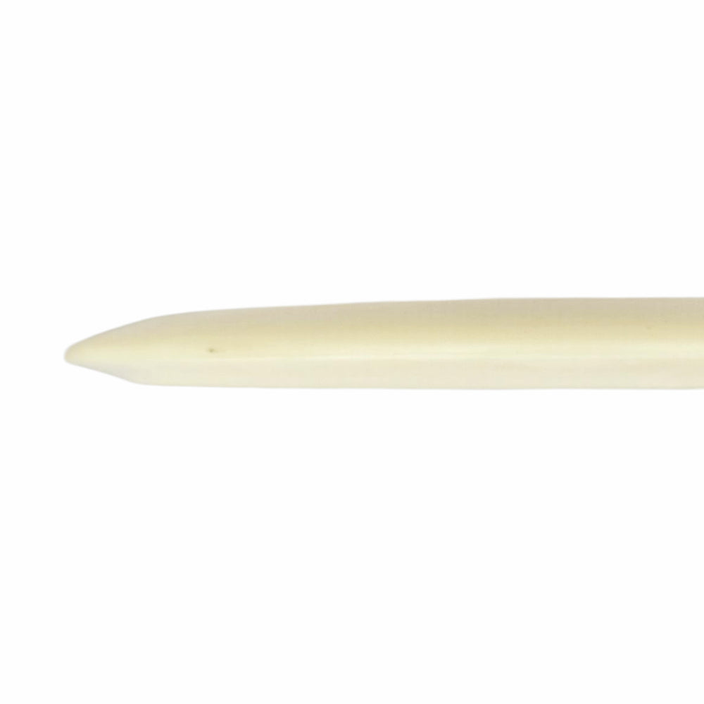 A close-up of the pointed end of a bone folder, an ivory tool for bookbinding, mirrors the precision found in Cyborg Superglow - PremierJUL mechanics.