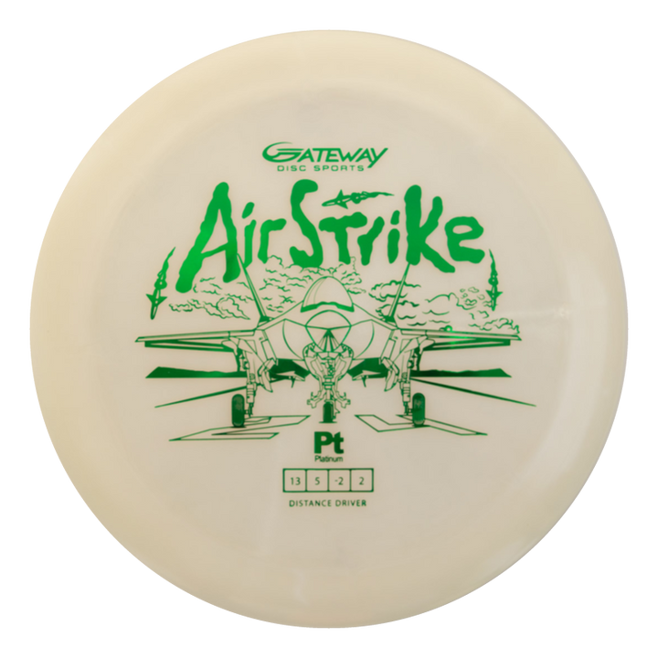The Airstrike - Platinum is a white long-range driver with green fighter jet artwork, the words "Air Strike," and specs from Gateway Disc Sports€”ideal for players seeking easy control, distance, and precision.