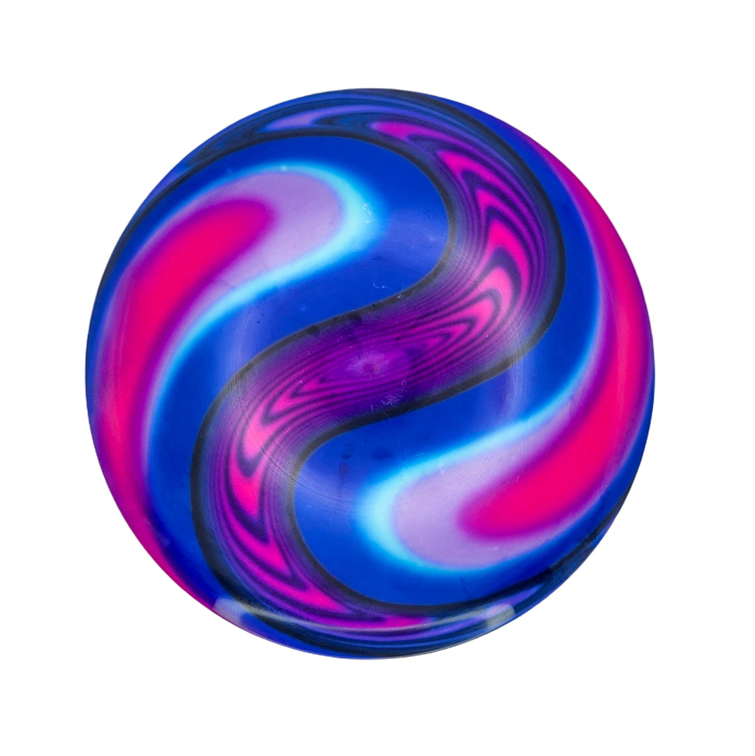 The Element NXT - Optic Dyes is a round bouncy ball with swirling blue, pink, purple, and white patterns, reminiscent of hand-dyed discs or a vibrant dye canvas.