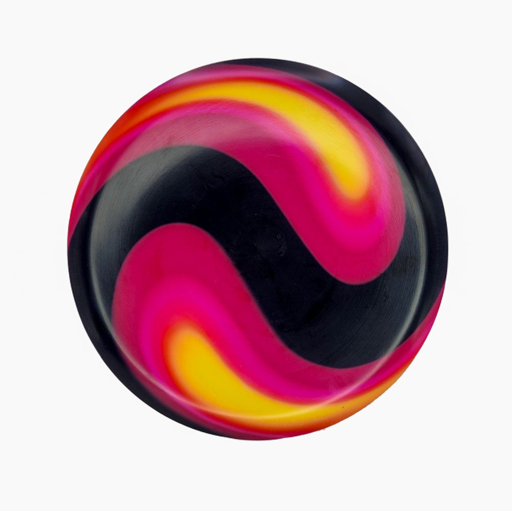 The Element NXT Optic Dyes ball features a round shape with a vibrant, swirling pattern of black, yellow, pink, and magenta on white—resembling the look of hand-dyed discs.