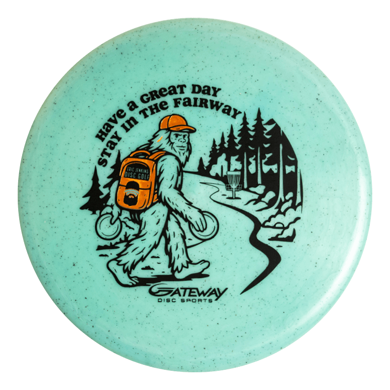 The Eric Jenkins Signature Series Chief - Diamond Hemp is a turquoise off-the-tee putter disc featuring Bigfoot carrying discs, walking down a forest path toward a basket, with —Have a Great Day, Stay in the Fairway—� text.