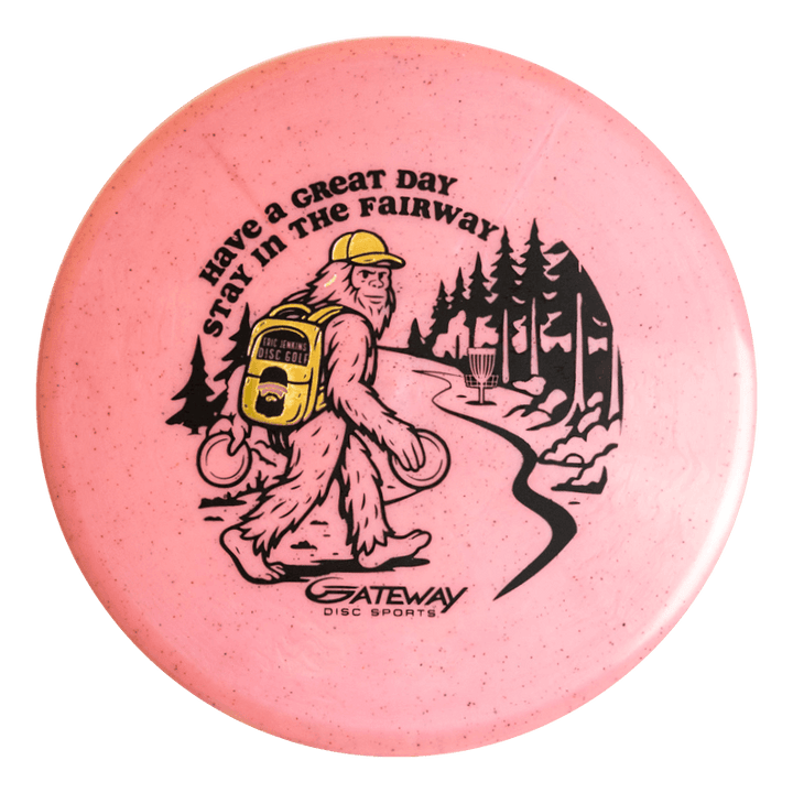 The Eric Jenkins Signature Series Chief - Diamond Hemp is a pink disc golf putter featuring Bigfoot carrying discs and a yellow backpack on a wooded path, with "Have a Great Day Stay in the Fairway" text. Ideal for unique art fans and low profile putters.