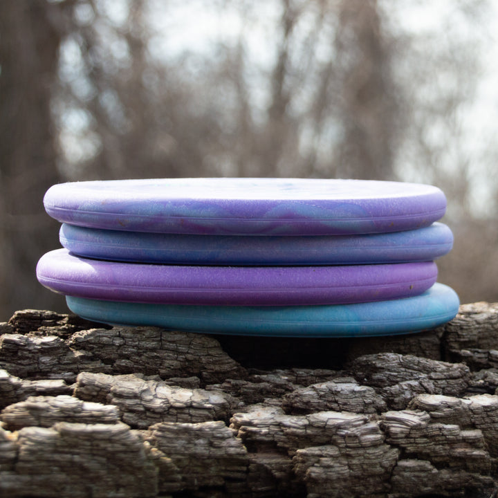 Four Ghoul - Chandler Kramer Signature Series discs, recognized for their reliable flight and forehand comfort, are stacked outdoors on a weathered wooden surface.