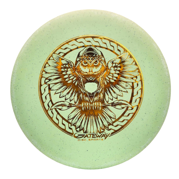 A light green Warlock SSS Hemp - PremierJUL disc golf disc, made with organic hemp, features a gold owl in flight and "Gateway Disc Sports" text at the bottom.
