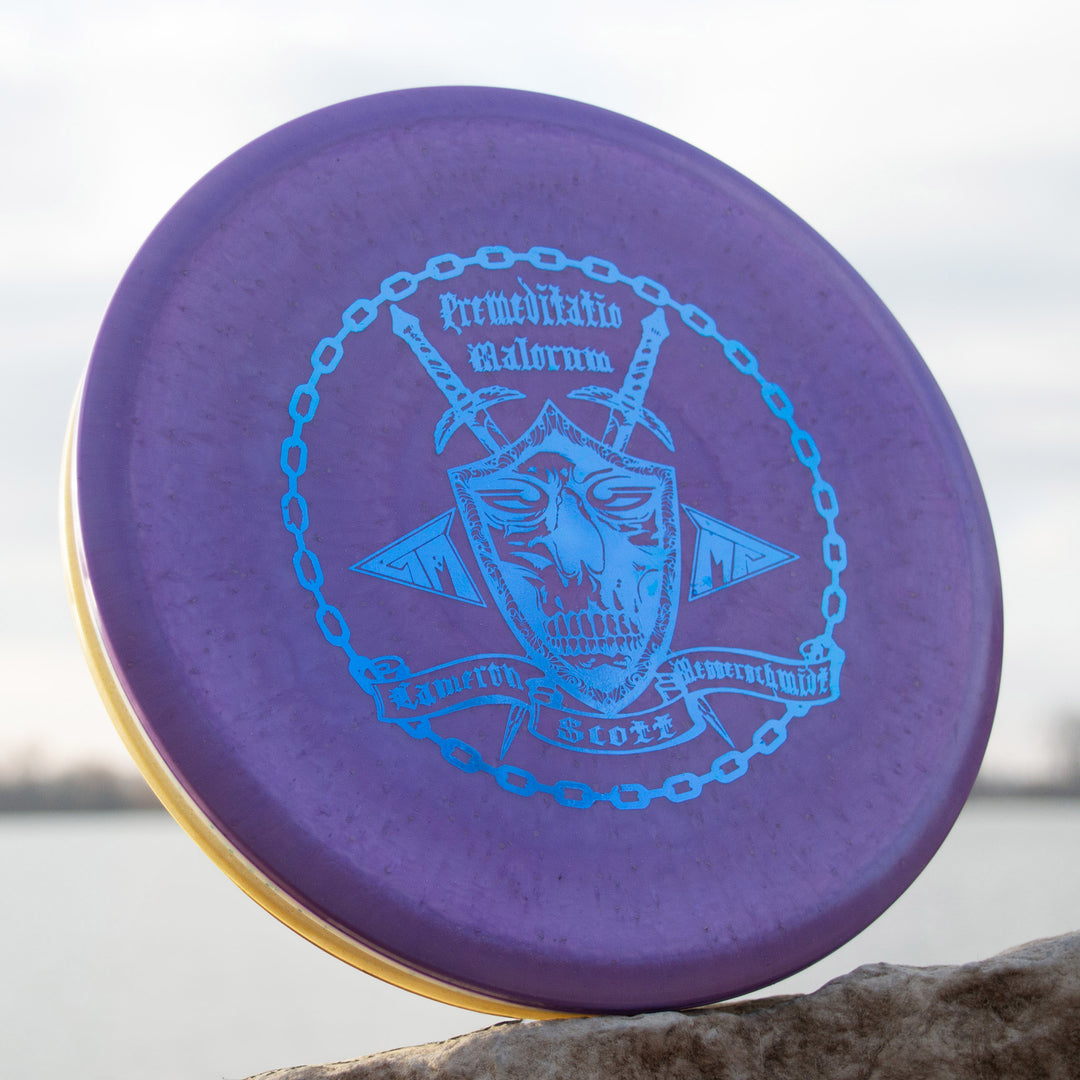Cam's Prophecy - Diamond Metal Flake: An overstable mid-range in a purple Diamond blend, featuring a blue horned face with chains graphic—ideal for your next round near the water.