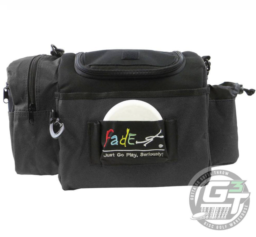 The Fade Gear Crunch Box Disc Golf Bag is a durable black bag with multiple pockets, a padded shoulder strap, a visible white disc, and a "Fade" logo patch on the front saying "Just Go Play. Seriously!" Perfect for everyday play.