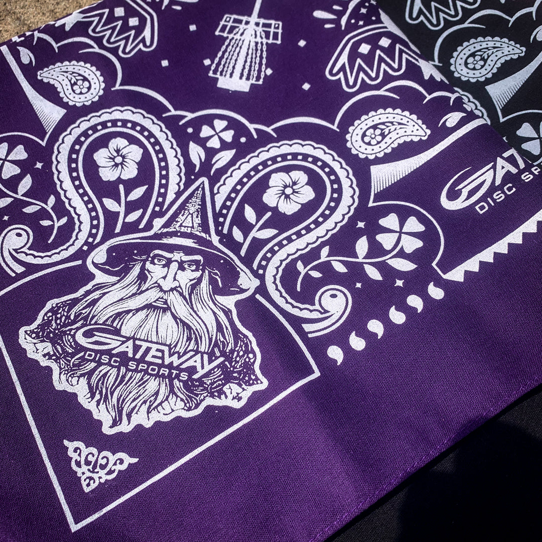 The Gateway Bandana is a purple cotton bandana with white designs of a wizard, floral patterns, Gateway logos, and the text —Gateway Disc Sports.—�.