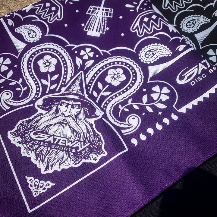 The Gateway Bandana is a purple cotton bandana with white designs of a wizard, floral patterns, Gateway logos, and the text —Gateway Disc Sports.—�.