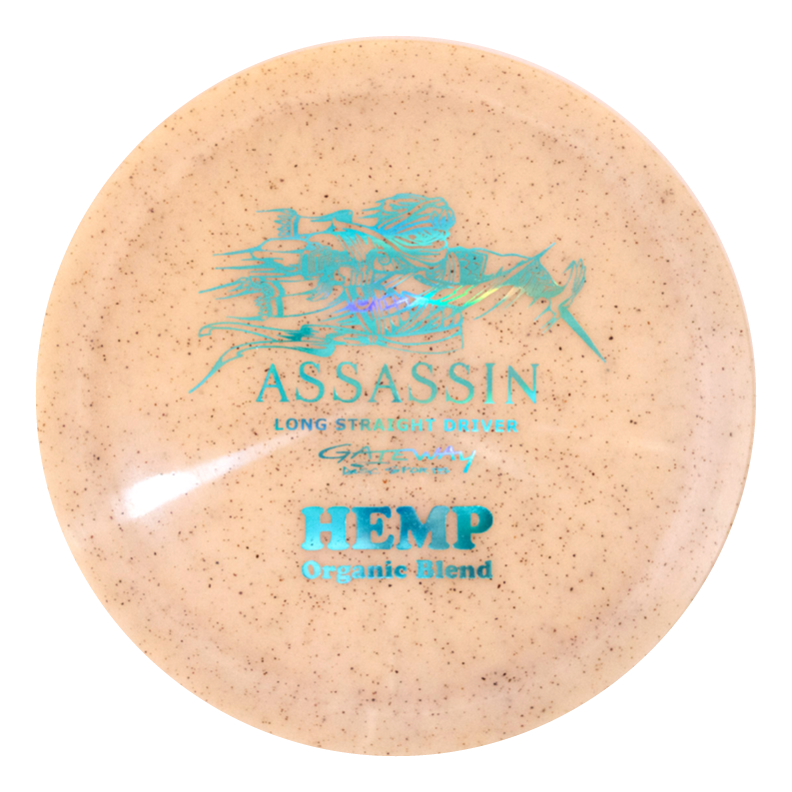 The Assassin - Diamond Hemp distance driver disc is beige with a blue graphic and features "ASSASSIN Long Straight Driver" and "Diamond Hemp Blend Organic" text on the front.