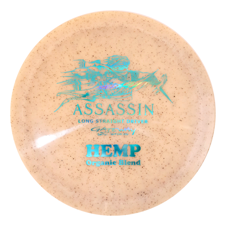 The Assassin - Diamond Hemp distance driver disc is beige with a blue graphic and features "ASSASSIN Long Straight Driver" and "Diamond Hemp Blend Organic" text on the front.
