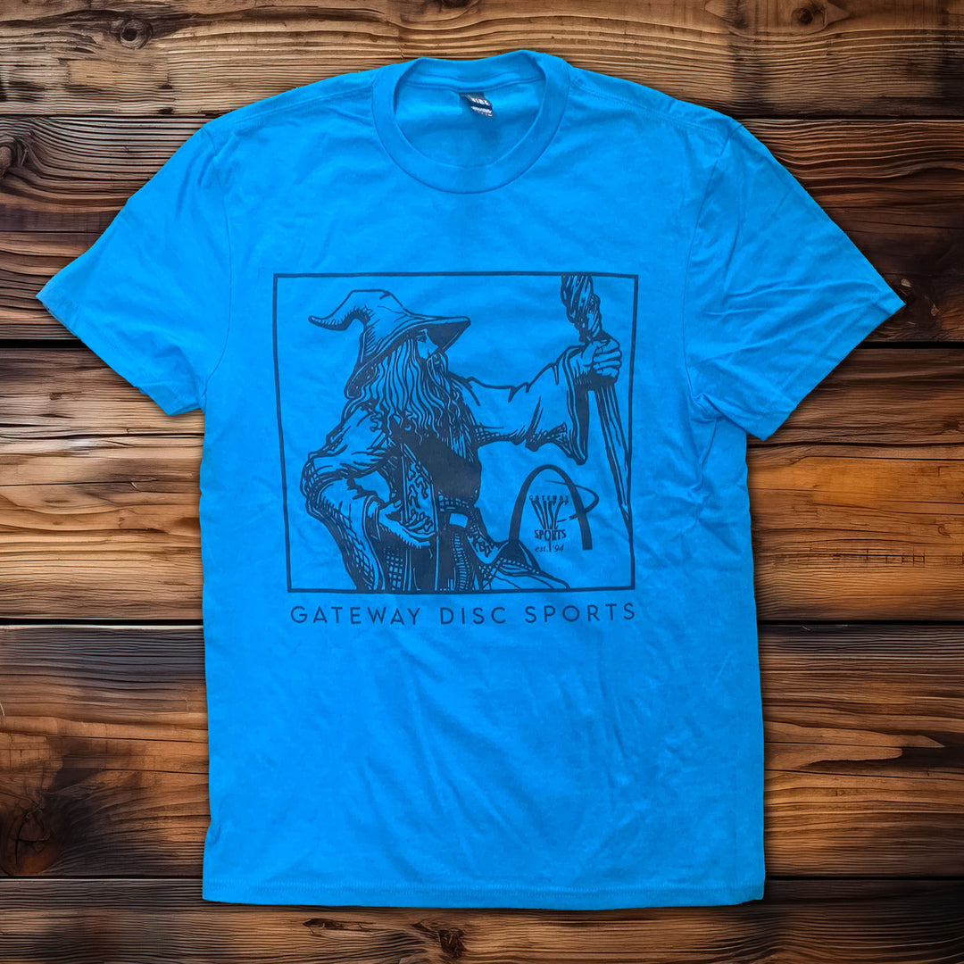 The Wizard T-shirt is a blue Gildan Softstyle featuring a line art wizard with staff and "GATEWAY DISC SPORTS" text below, displaying a unique retro-style logo.