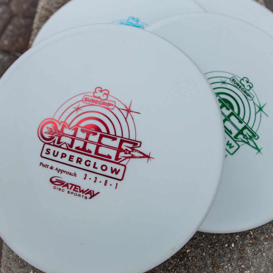 Three Gateway disc golf putters labeled €œChief - Suregrip Superglow€� in various colors, including a beaded rim low profile design, stacked on a stone surface.