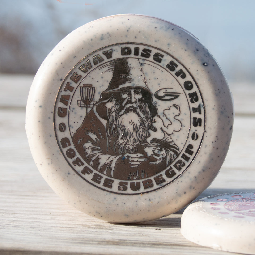 The Coffee Minis is a beige disc golf putter with a wizard holding coffee and €œGateway Disc Sports Coffee Suregrip€� text€”perfect for coffee lovers and Warlock enthusiasts.