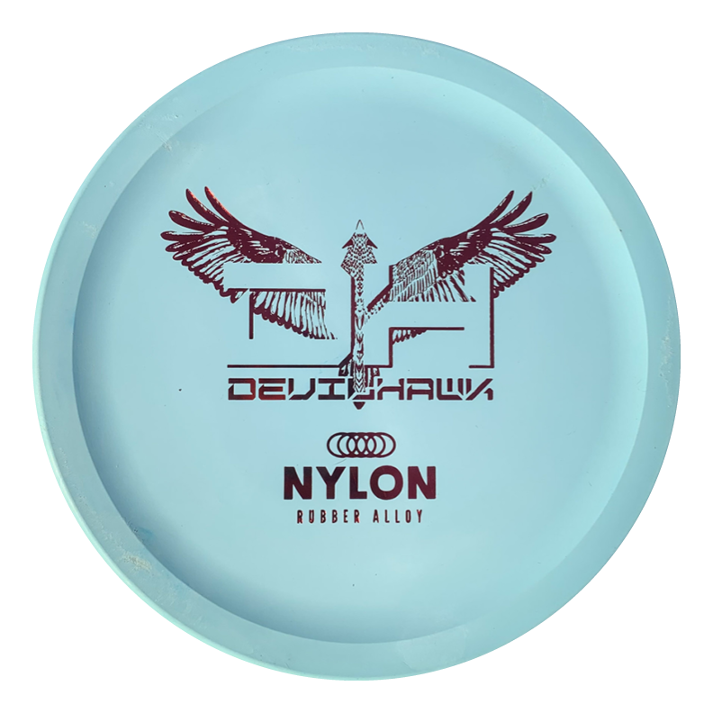 A light blue Devilhawk - Suregrip Nylon putt and approach disc with "DEVILHAWK" and "NYLON RUBBER ALLOY" in red, plus an abstract winged design and arrow.