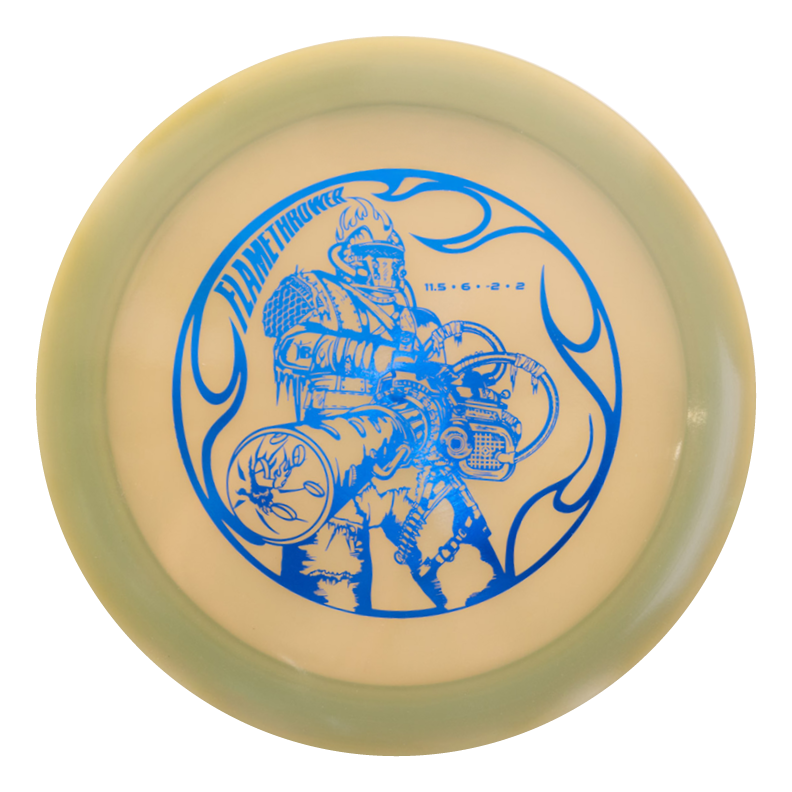 A round disc with a greenish rim, featuring a blue illustration of a person in a flame-resistant suit wielding a flamethrower, and the text "Black Zombie Flamethrower €“ Hyper Diamond" above the figure.