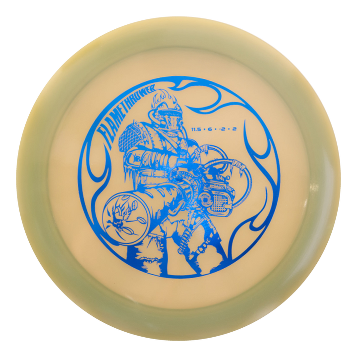 A round disc with a greenish rim, featuring a blue illustration of a person in a flame-resistant suit wielding a flamethrower, and the text "Black Zombie Flamethrower €“ Hyper Diamond" above the figure.