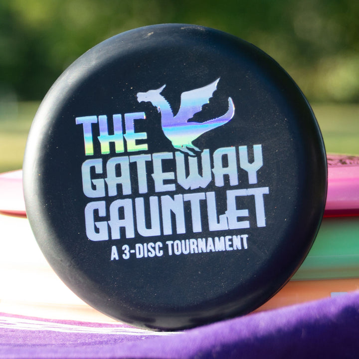 The Gateway Gauntlet - 3 Disc Players Pack features a black disc with a holographic dragon logo and "The Gateway Gauntlet: A 3-Disc Tournament"—a striking pick for any disc golf tournament or new disc collectors from Gateway Disc Sports.