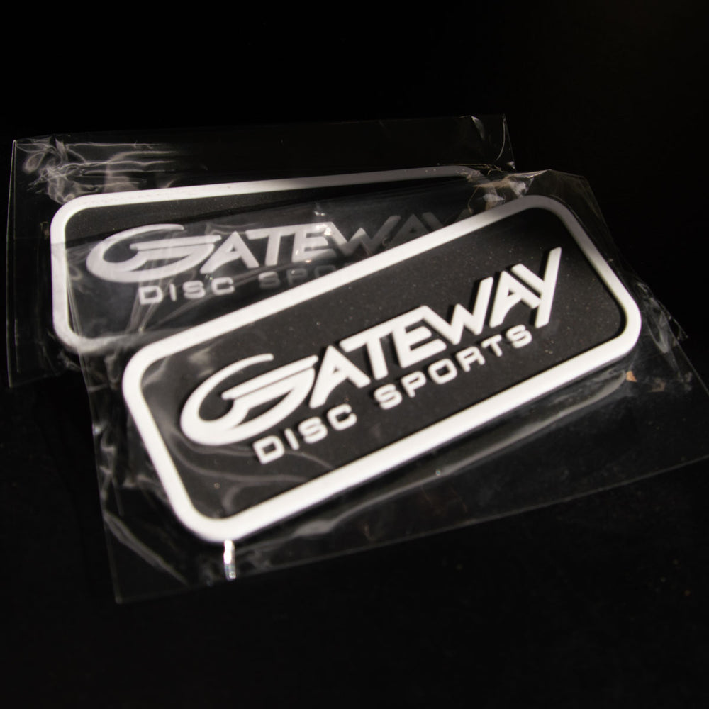 Two Gateway Velcro Logo Patches—rectangular, black and white, with velcro backs—are sealed in plastic packaging and shown on a dark surface.