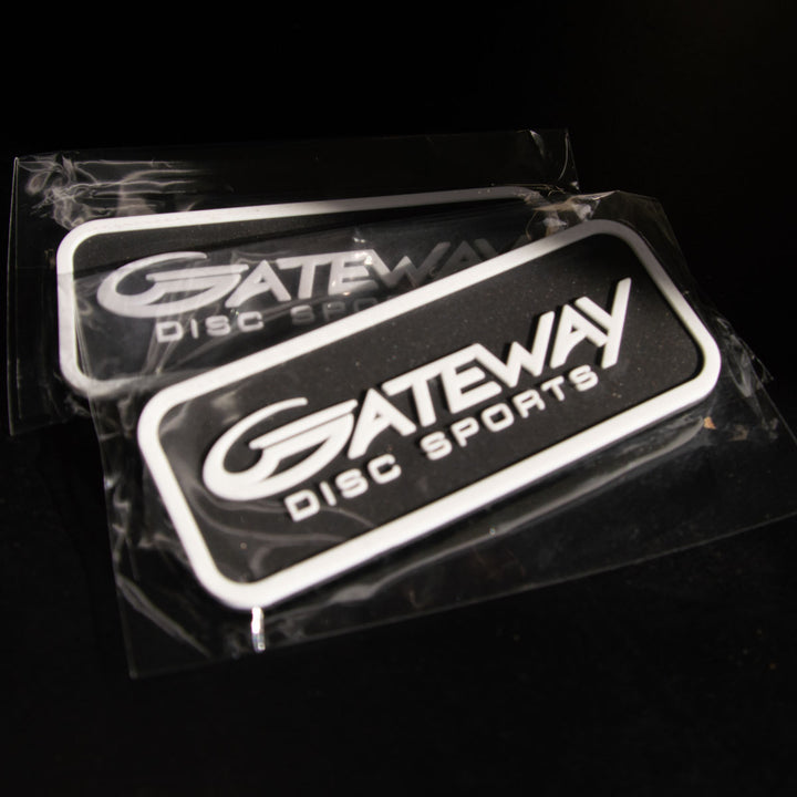 Two Gateway Velcro Logo Patches—rectangular, black and white, with velcro backs—are sealed in plastic packaging and shown on a dark surface.