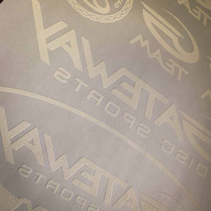 Close-up of an Iron-On Team G Logo Sheet featuring multiple embossed Gateway Disc Sports logos and text€”ideal for team players who want custom designs on heat transfer paper.