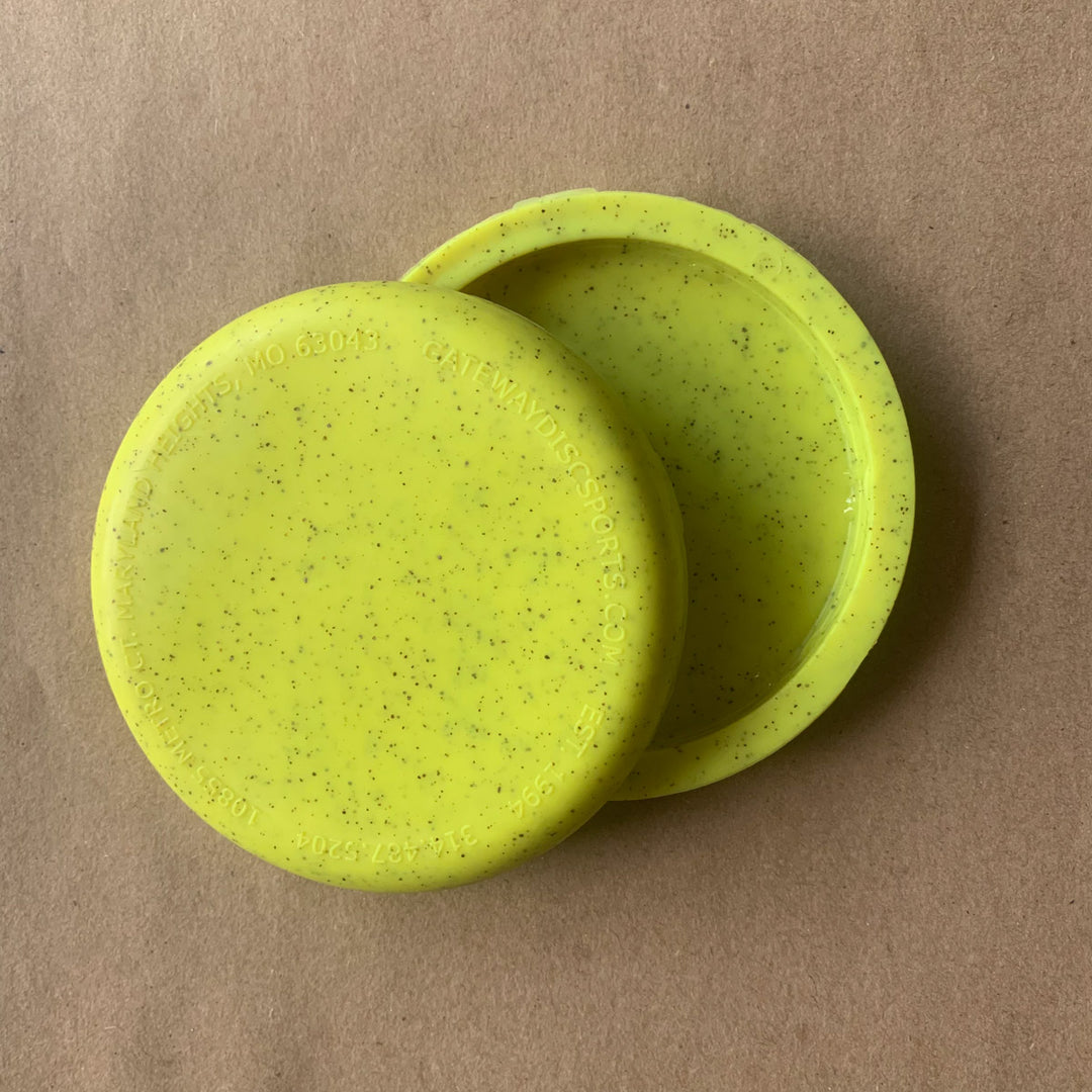 Two blank mini discs made from hemp, slightly overlapping on a plain brown surface—perfect for use as custom stamped mini markers or promotional giveaways. Product: Mini (Small) - Hemp - Blank.