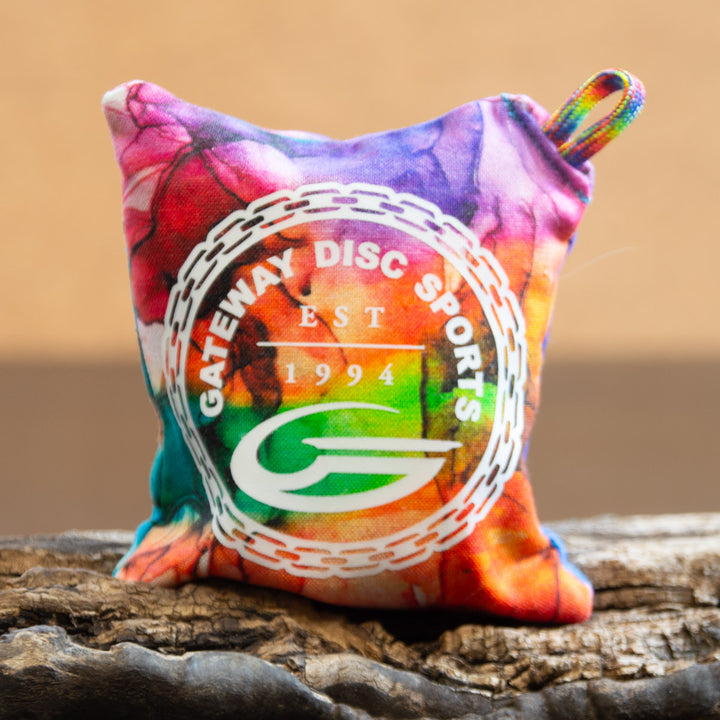 The Gateway Disc Sports x Jaybirdz Dry Bag is a small, multicolored, handcrafted chalk bag with "Gateway Disc Sports EST 1994" and chain design—perfect for enhancing grip during play.