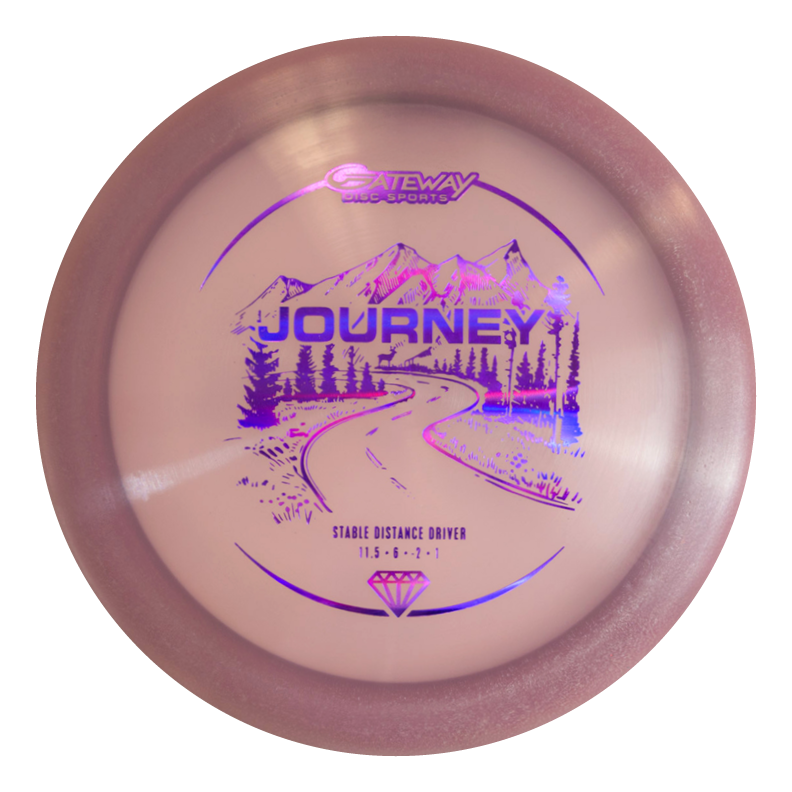 A pink long-range distance driver named "Journey - Diamond" by Gateway Disc Sports, featuring a purple winding road, mountains, and trees graphic€”designed for controllable flight on the course.
