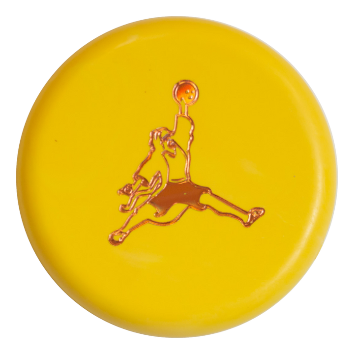 A yellow circular button featuring the Air Dude Mini (Large) - SureGrip stamp—a stylized person holding a ball—stands out at the center, inspired by the dynamic look of SureGrip mini accessories in vibrant colors.