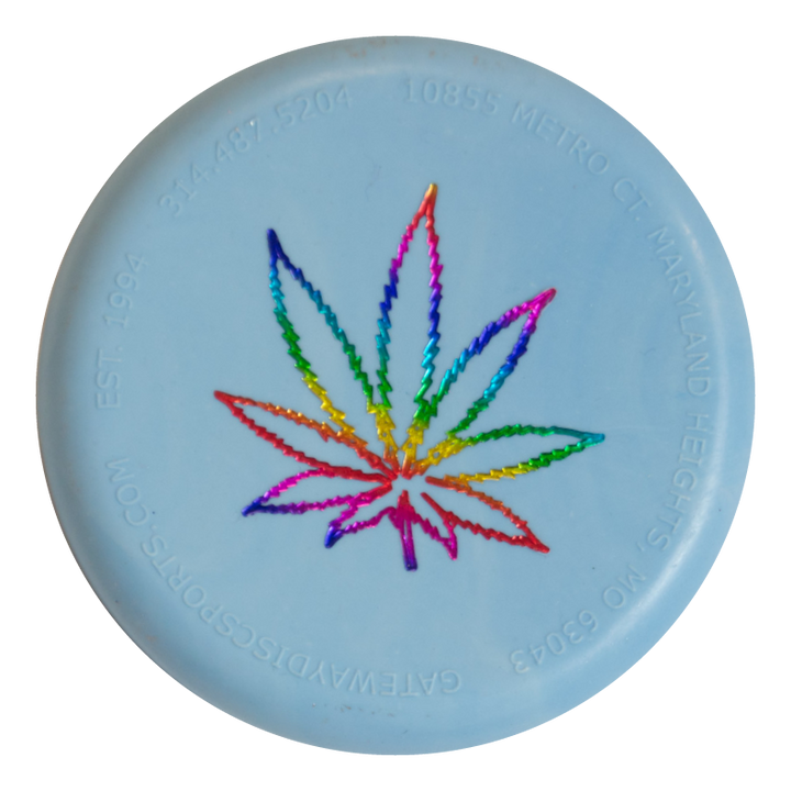 The Mini (Small) - SureGrip™ Leaf is a light blue disc featuring an assorted-colored mini hemp leaf outline in the center and embossed contact info along the edge.