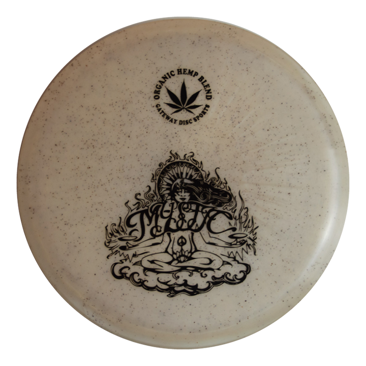 The Mystic - Diamond Hemp is a beige frisbee made from an organic hemp blend, featuring a black meditating figure and "MYSTIC" on the front, designed for controllable mid-range and straight flights.