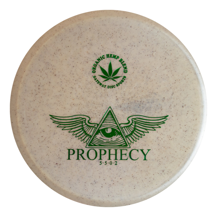 The Prophecy - Diamond Hemp is an overstable white mid-range disc golf disc featuring green graphics (eye in triangle with wings), "PROPHECY," flight numbers 5 5 0 2, and a hemp plant logo labeled "ORGANIC HEMP BLEND" for reliable flights.