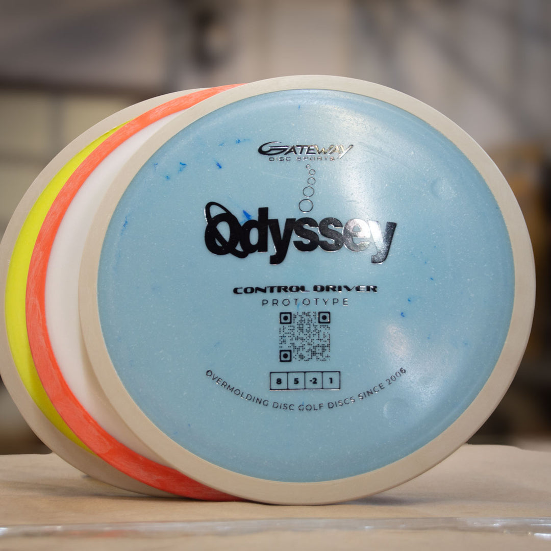 Three disc golf discs are stacked vertically, with the front blue disc labeled "Prototype 93" by Gateway, featuring a QR code and innovative dual-material technology in its overmolded design details.