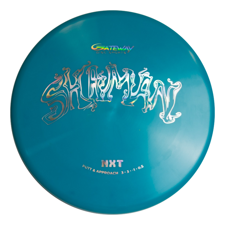 The Shaman - NXT is a teal Gateway disc golf putter with a flat 25° nose, no bead, "Shaman" in stylized white text, and "NXT Putt & Approach 3-3--1-0.5" printed below.