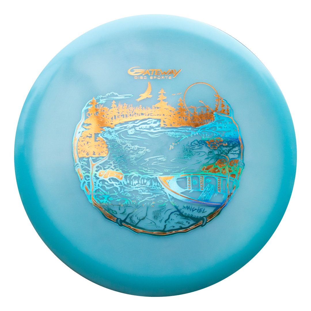 The Sam Smigiel's Element - NXT Color Superglow is a blue mid-range disc golf disc with gold and blue river, trees, bridge, and bird art, featuring the "Gateway Disc Sports" logo and offering unbelievable glide.