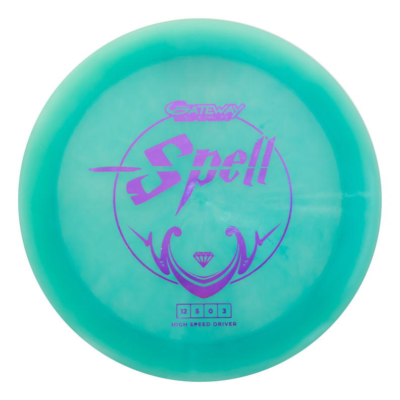 A teal overstable Spell - Diamond driver disc golf disc featuring the word "Spell" and Gateway logo in purple on top, designed for powerful throws in windy conditions.
