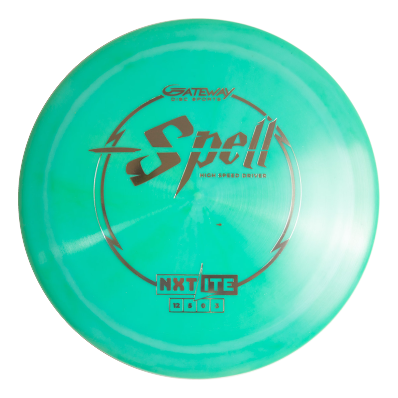 The Spell - NXT Lite is a teal overstable disc golf driver with bold black and silver text, engineered for wind-crushing power throws and consistent full-throttle performance.