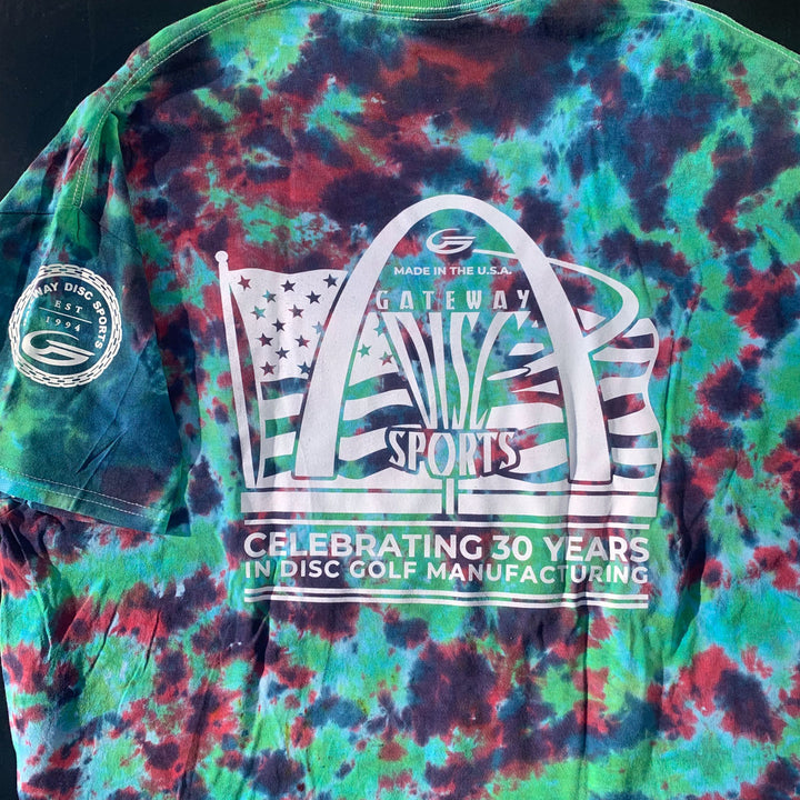 30th Anniversary - Tie Dyed T-Shirt featuring the Gateway Circle of Chains logo, American flag, and "Celebrating 30 Years in Disc Golf Manufacturing." Sleeve patch reads "Gateway Disc Sports 1994.