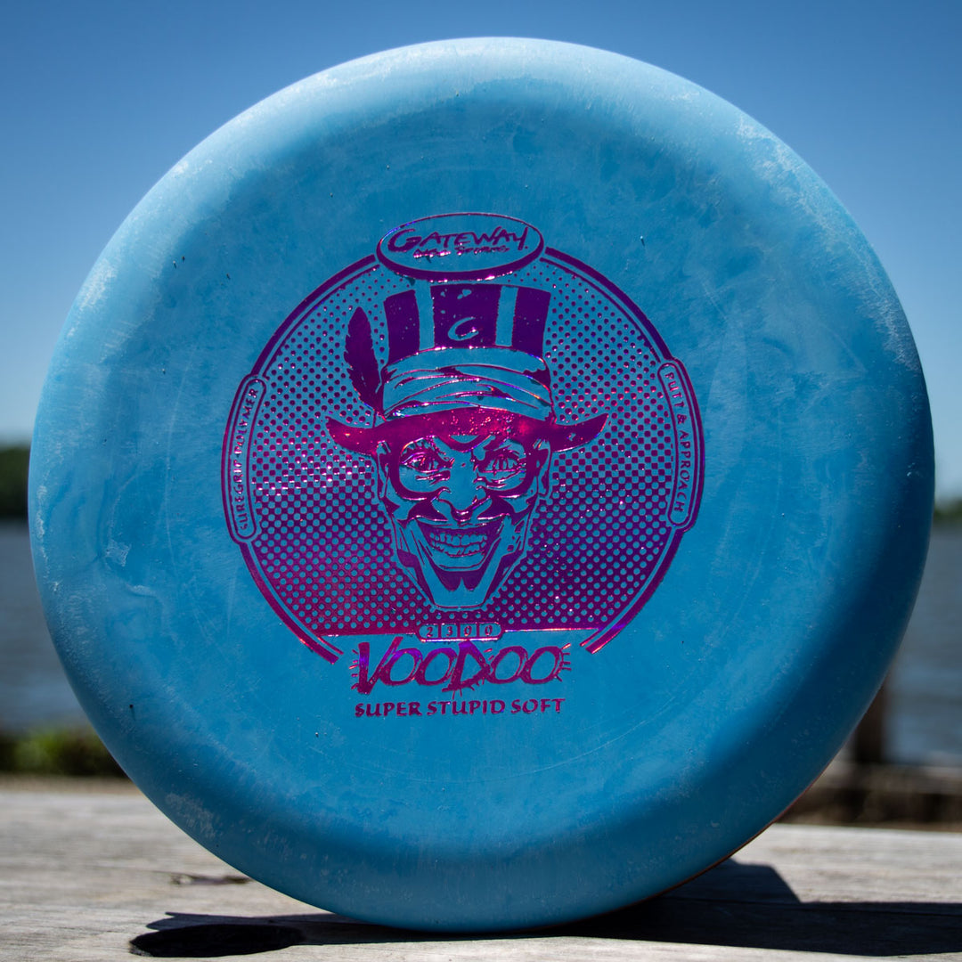A blue Voodoo - Suregrip - SSS disc golf putter with a purple grinning magician graphic and "Gateway Disc Sports" on the front—perfect as a straight putter or broken-in Wizard for reliable clutch lay-ups.