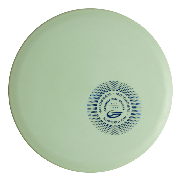 A light green, overstable Warrior - SureGrip™ Superglow frisbee featuring a circular blue logo and the text "Superglow," "Montagu Disc Golf," and "Warrior" near the center.