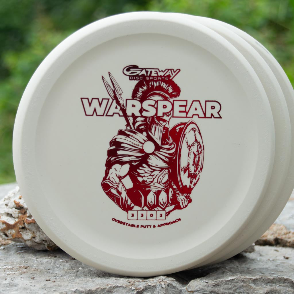A white, low profile Warspear - Suregrip putt and approach disc with an illustration of a warrior holding a spear and shield, and the model name above.
