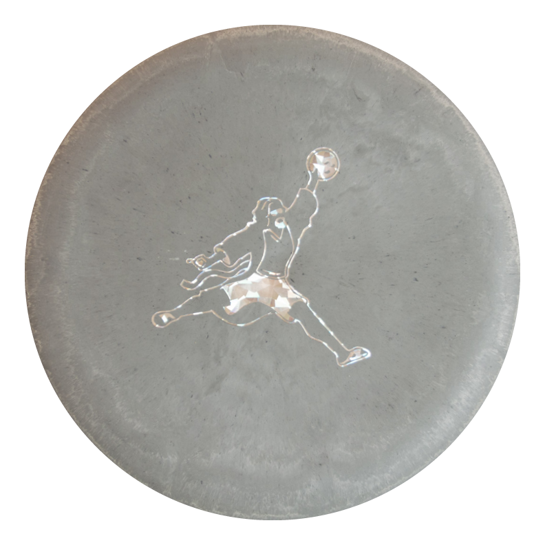 The Wizard Lunar - Air Dude features a round, gray concrete design with a central white silhouette of a person in motion holding a ball, capturing the essence of Gateway Disc Sports putters and disc golf.