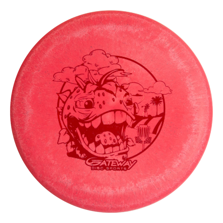 The Wizard Strawberry Hemp is a red disc golf disc with a cartoon dinosaur head, trees, a basket, and "Gateway Disc Sports" logo€”ideal for mid-range drives or pairing with your favorite stable putter.